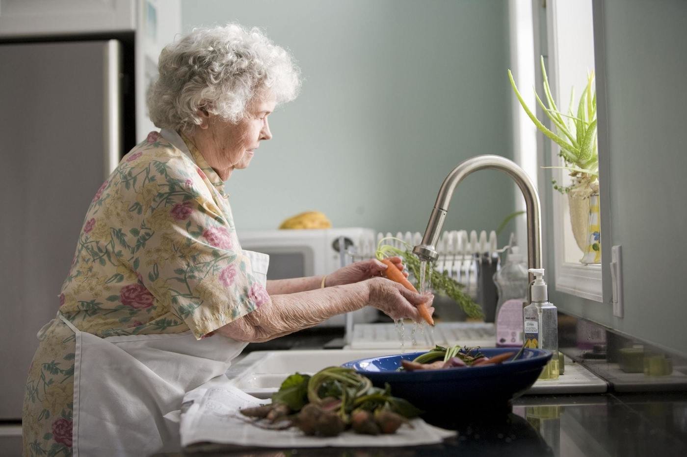 Aged lady washing food